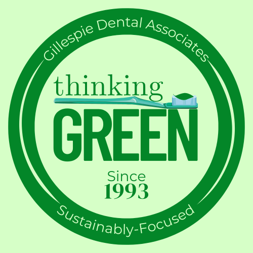 Round Green Badge with a toothbrush and the words "thinking green since 1993" in Asheville, NC